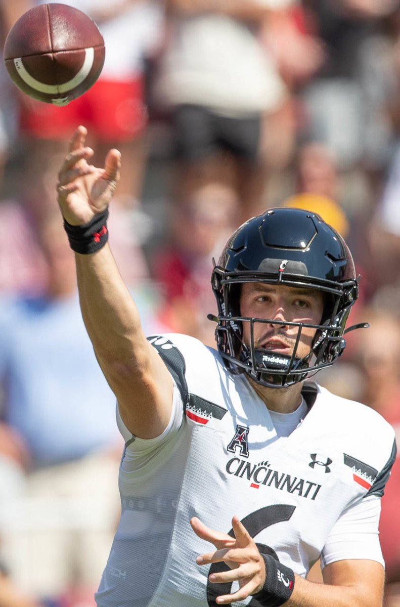Cincinnati quarterback Ben Bryant appears has already thrown one pick and almost threw a second as Arkansas forced a punt on 4th & 15.